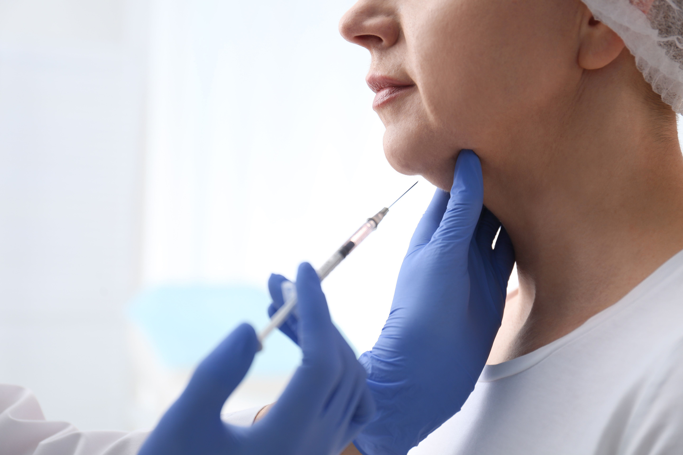 Mature Woman with Double Chin Receiving Injection in Clinic, Clo
